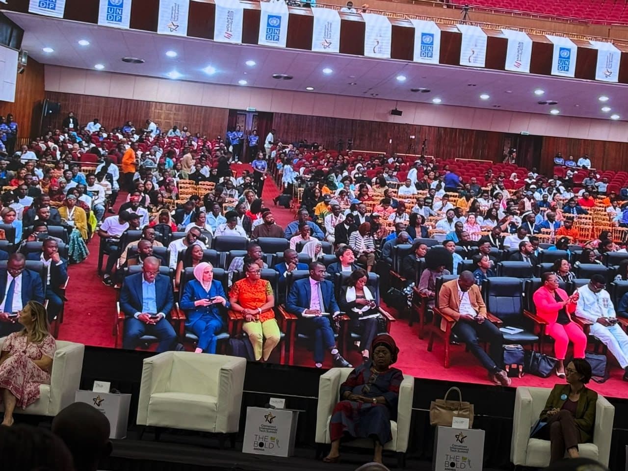 Delegates filling the auditorium at the Palais des Congrès beneath the summit banners